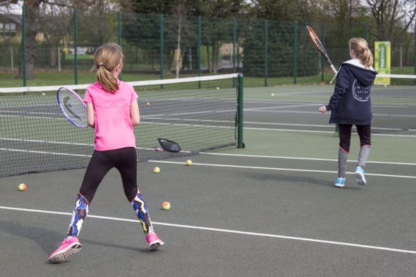 Children learn to play tennis in Richmond